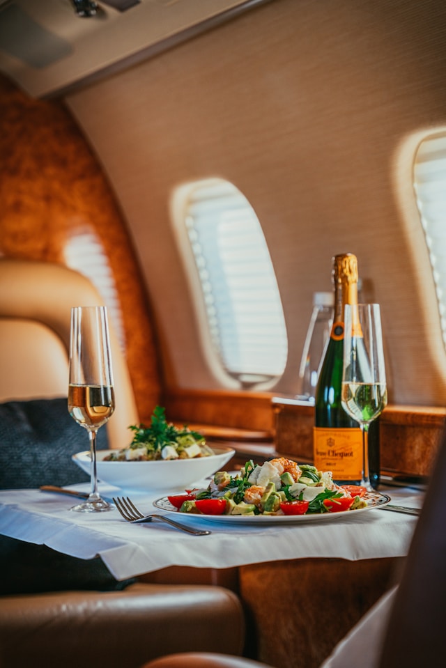 Private jet dining experience — champagne service during a bespoke journey